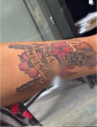 Traditional crossed-swords tattoo with banner lettering and cherry blossoms, by Aaron Raines