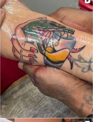 Color traditional hand and bird tattoo on wrist by Aaron Raines