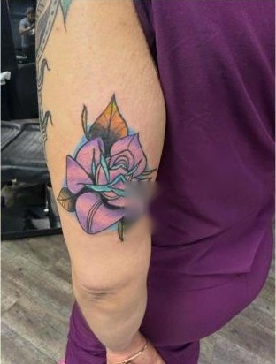 Color traditional rose tattoo on upper arm by Aaron Raines
