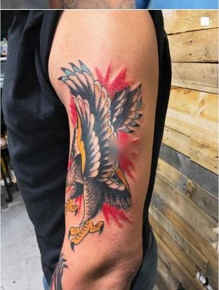 Color traditional eagle tattoo on upper arm by Aaron Raines