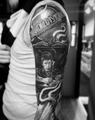 Black and grey portrait sleeve with "the world is yours" lettering, by Thelmo