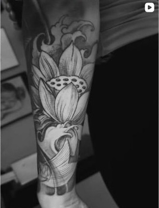Black and grey lotus flower forearm tattoo by Thelmo