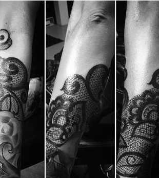 Black lace-pattern forearm tattoo by Thelmo