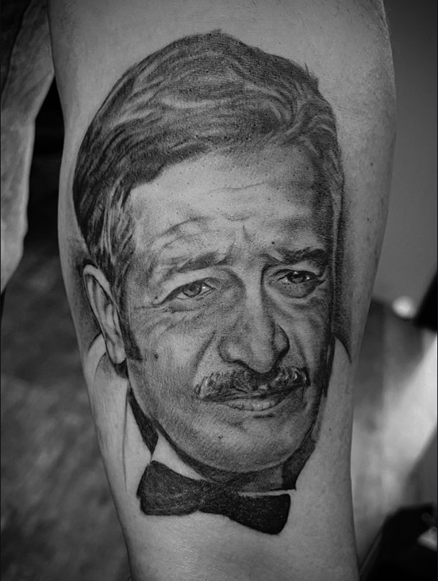 Black and grey portrait of a man in a bow tie